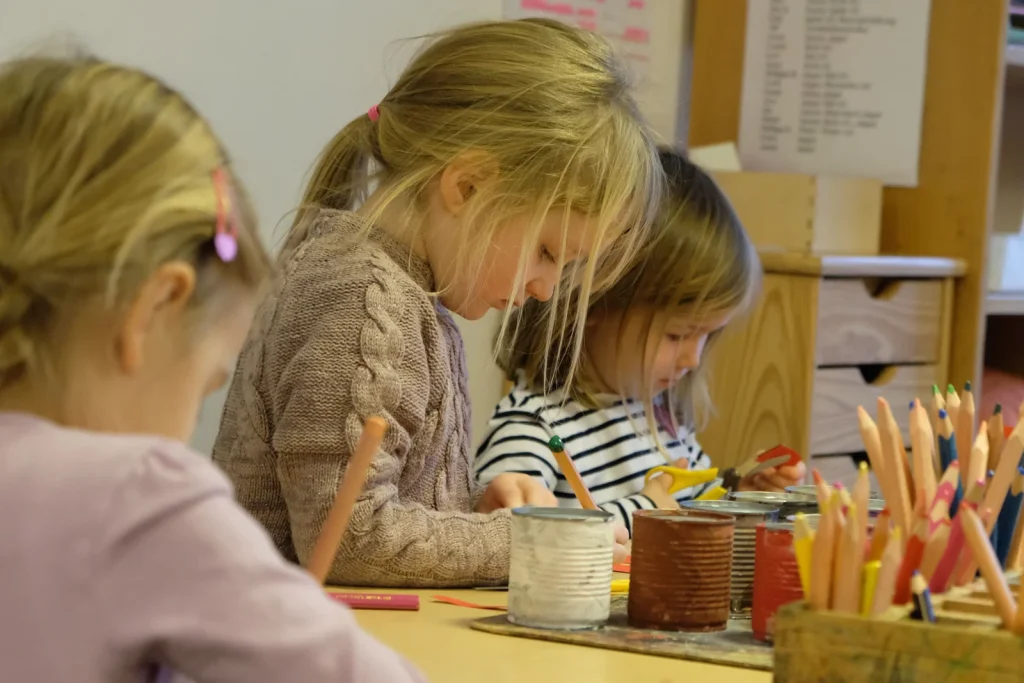 Kinder malen gemeinsam an einem Tisch in der Kita Blumenallee.